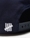UNDEFEATED SCRIPT LOGO SNAPBACK