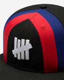 UNDEFEATED X NE STRIPE SNAPBACK